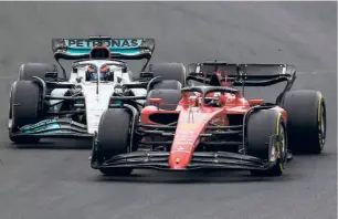  ?? AFP ?? Slow pace: George Russell (left) and Charles Leclerc compete during the Hungarian Grand Prix. Due to hard tyres, Leclerc kept falling behind and eventually finished sixth.
