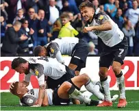  ??  ?? PAT A BOY Paterson is mobbed after hitting Derby’s winner