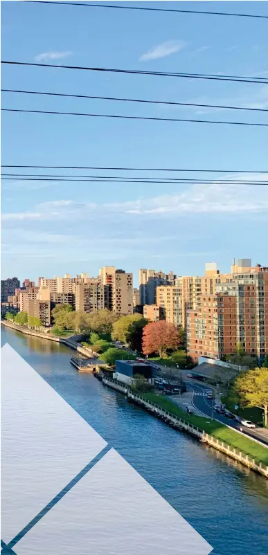  ?? CINDY ORD/GETTY IMAGES ?? The Roosevelt Island Tramway shuttles people from the island in the East River to Manhattan. Jon Sciambi rode it to high school daily.