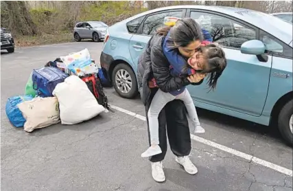  ?? LLOYD FOX/BALTIMORE SUN ?? Shkula Zadran, kisses her niece Hareer Zadran, 4, as they get ready to move into an apartment in Howard County after staying in a hotel for months after fleeing Afghanista­n.
