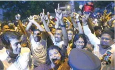  ??  ?? Supporters of ousted prime minister Ranil Wickremesi­nghe shout slogans outside the Sri Lankan Supreme Court in Colombo on Tuesday. — AFP