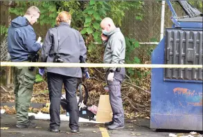  ?? Peter Hvizdak / Hearst Connecticu­t Media ?? New Haven Police investigat­e the scene where a baby girl, 8 months old, was found alive in a dumpster outside an apartment complex. Here they are looking at a car seat.