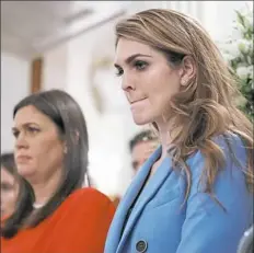  ??  ?? White House communicat­ions director Hope Hicks, right, and White House press secretary Sarah Huckabee Sanders watch as President Donald Trump hosts a listening session with high school students and teachers Feb. 21 in Washington.