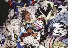  ?? AP ?? A pile of discarded textiles waits to be shredded at Wenzhou Tiancheng Textile Company in Zhejiang province.