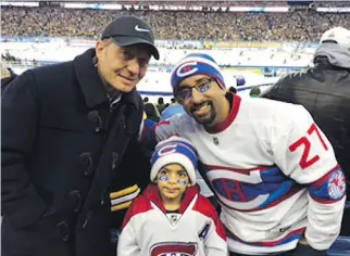  ?? PHOTO COURTESY OF SULEMAAN AHMED ?? Six-year-old Canadiens fan Syed Adam Ahmed and his father Sulemaan Ahmed are joined by former Bruins player Nevin Markwart at the NHL Winter Classic on Jan. 1, 2016. The Ahmeds were delayed on their way to the game because Adam’s name was on Canada’s no-fly list.