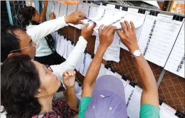  ?? PHA LINA ?? People search for their names on the new NEC voter lists in Phnom Penh’s Tonle Bassac commune in January.