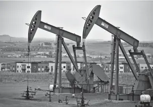  ?? MATTHEW BROWN/ASSOCIATED PRESS ?? Pump jacks stand with apartments in the background last month on the outskirts of Watford City, N.D., part of McKenzie County. It’s the fastest-growing county in the U.S, according to new figures from the Census Bureau.