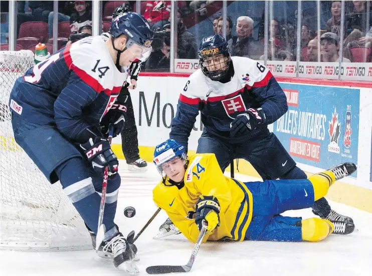  ?? — THE CANADIAN PRESS FILES ?? Sweden’s Elias Pettersson is hooked during quarter-final action at IIHF World Junior Championsh­ip hockey in Montreal in January.