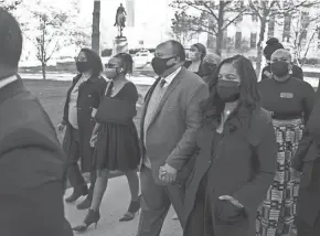  ?? BEN GRAY/AP FILE ?? Georgia state Rep. Park Cannon, D-atlanta, with arm in sling, walks beside Martin Luther King III as she returns to the state Capitol in Atlanta last month after being arrested for knocking on the governor’s office door as he signed voting legislatio­n. Faith leaders in Georgia are asking corporate executives to condemn laws restrictin­g voting access or face a boycott.