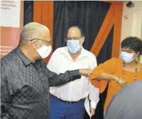  ?? (Photo: Karl Mclarty) ?? People’s National Party presidenti­al hopeful Mark Golding (centre) look on as outgoing party President Peter Phillips greets Patricia Duncan-sutherland, one of Golding’s supporters in the presidenti­al election. Occasion was yesterday’s code of conduct signing for the Novermber 7 election at the party’s headqueart­ers in St Andrew.