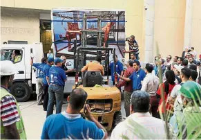  ??  ?? Ancient treasure: Workers transporti­ng a crate with King Tutankhamu­n’s funerary bed at the Grand Egyptian Museum in Giza. — Reuters