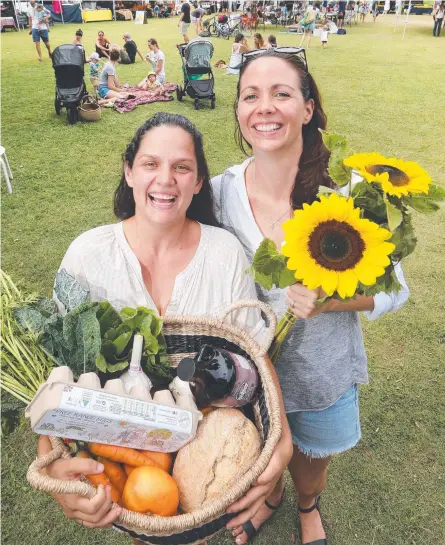  ?? Picture: GLENN HAMPSON ?? Hannah Sheppard and Chana Warry-Stokes celebrate their new farmers market at Currumbin.