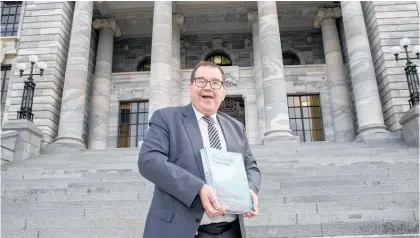  ?? Photo / Mark Mitchell ?? A spruced up Grant Robertson with copies of his Budget 2020 on Parliament steps.