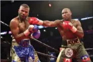  ?? FRANK GUNN — THE CANADIAN PRESS VIA AP ?? Adonis Stevenson, right, hits Badou Jack with a right during their WBC light heavyweigh­t championsh­ip boxing match in Toronto on Saturday.