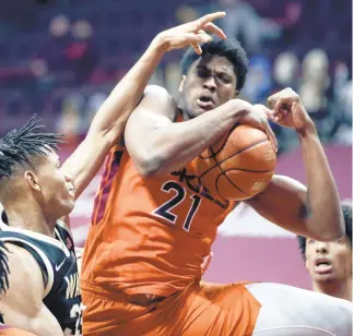  ?? MATT GENTRY/ASSOCIATED PRESS ?? Virginia Tech’s John Ojiako grabs a rebound in front of Wake Forest’s Ody Oguama, left, on Saturday in Blacksburg.