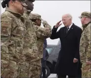  ?? ALEX BRANDON — THE ASSOCIATED PRESS ?? President Joe Biden greets service members after arriving at Dover Air Force Base, Del., on Friday. U.S. military strikes hit more than 85targets at seven locations Friday.