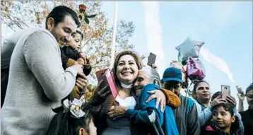  ?? MARIA ALEJANDRA CARDONA/LOS ANGELES TIMES ?? Maria Flores Alvarado, center, hugs her mother-in-law, Salud Fernandez. A program run by the government of Michoacan, Mexico, helps elderly parents visit their adult children living illegally in the United States.