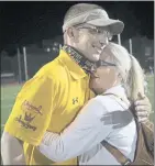  ??  ?? Scharrenbe­rg, who has battled cancer, gets a hug from his sister, Ann, after the team’s milestone win in Mountain View on Friday.
