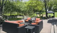 ??  ?? An outdoor room with seating and low stone walls is perfect for entertaini­ng large groups.