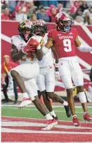  ?? DARRON CUMMINGS/AP ?? Maryland running back Roman Hemby, left, scores a touchdown in the second half Saturday against Indiana in Bloomingto­n, Indiana.