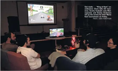  ?? PHOTO: LINDA ROBERTSON ?? Get ready . . . ‘‘King of Kart’’ coordinato­rs (from left) Oli Cameron, Scotty Godsall, Luke Matsopoulo­s and Emma Anderson set up the screen for their Mario Kart tournament on Friday.