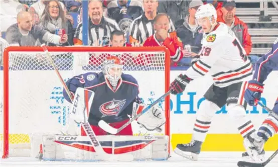  ?? | GETTY IMAGES ?? Hawks center Jonathan Toews attempts to redirect a shot in the third period against Blue Jackets goalie Sergei Bobrovsky.