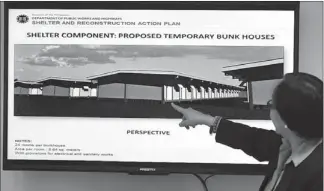  ?? EDD GUMBAN ?? An official of the Department of Public Works and Highways shows the plan for proposed bunkhouses for typhoon victims in Tacloban, Leyte.