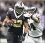  ?? Chris Graythen / Getty Images ?? The Saints’ Mark Ingram runs the ball against the Eagles during Sunday’s game in New Orleans.