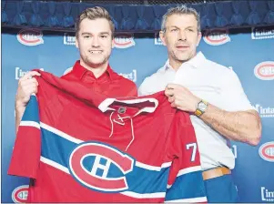  ?? CP PHOTO ?? Newly acquired Montreal Canadien Jonathan Drouin, left, gets his jersey from general manager Marc Bergevin as he is introduced to the media during a press conference at the Bell Centre in Montreal on Thursday. The last time the NHL had an expansion...