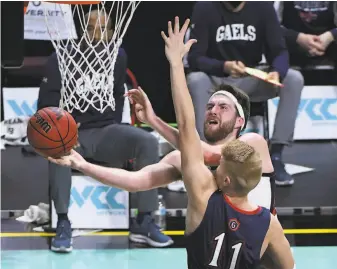  ?? Ethan Miller / Getty Images ?? Gonzaga’s Drew Timme tries to maneuver around St. Mary’s Matthias Tass. Timme went 8for11 from the floor and scored a gamehigh 18 points. He also pulled down eight rebounds.