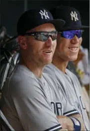  ?? BRUCE KLUCKHOHN — THE ASSOCIATED PRESS ?? New York Yankees third baseman Todd Frazier sits in the dugout with Aaron Judge during a baseball game against the Minnesota Twins on Wednesday in Minneapoli­s. The Yankees acquired Frazier on Tuesday in a trade with the Chicago White Sox.