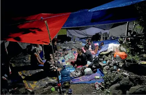  ?? AP ?? Earthquake survivors rest under a makeshift tent in Cianjur, West Java, Indonesia.