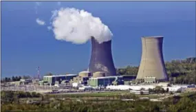  ?? THE ASSOCIATED PRESS ?? Plumes of steam drift from a cooling tower of the Perry Nuclear Power Plant along Lake Erie in North Perry, Ohio. Akron-based FirstEnerg­y Corp.’s customers in Ohio would pay higher rates under a proposed bailout for the state’s two nuclear plants, the...