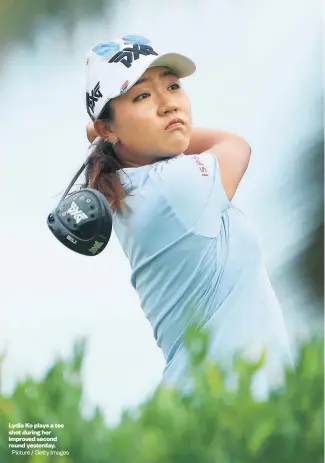  ?? Picture / Getty Images ?? Lydia Ko plays a tee shot during her improved second round yesterday. Golf