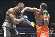  ?? Icon Sportswire via Getty Images ?? Cassius Chaney, right, battles Jon Bolden during their heavyweigh­t bout on Oct. 5 at the Mohegan Sun Arena in Uncasville. Chaney defeated Bolden via decision.