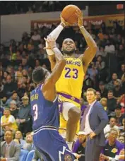  ?? K.C. Alfred San Diego Union-Tribune ?? LeBRON JAMES of the Lakers shoots over Denver’s Torrey Craig during Sunday’s preseason game.