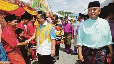  ?? [FOTO ASWADI ALIAS/BH] ?? Ahmad Razif diiringi Ketua Polis Terengganu, Datuk Rosli Ab Rahman (kanan) bersalaman dengan anggota polis pada Majlis Rumah Terbuka Aidilfitri PDRM Kontinjen Terengganu, semalam.