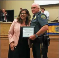  ?? LUCAS RODGERS – DIGITAL FIRST MEDIA ?? Deborah Ryan, county coordinato­r with the Safe and Healthy Communitie­s Initiative, presents a certificat­e or recognitio­n to Coatesvill­e Police Chief Jack Laufer.