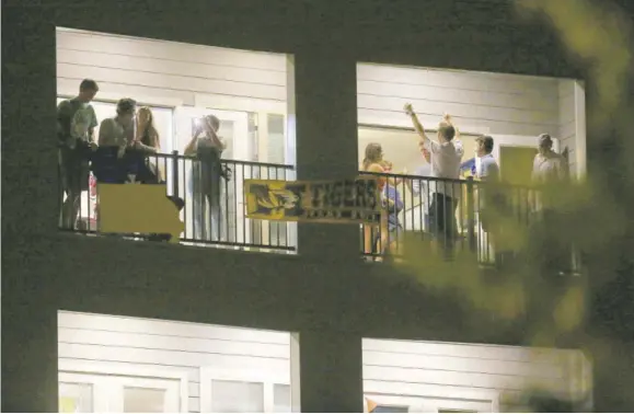  ?? (Photo: AP) ?? In this September 1, 2020 file photo, partiers congregate on the balcony of a downtown apartment in Columbia, Mo, near the University of Missouri campus. College towns across the US have emerged as novel coronaviru­s hot spots in recent weeks as schools struggle to contain the virus. In many cases, surges have been blamed on off-campus parties. The University of Missouri announced this week that it expelled two students and suspended three others for violating rules meant to slow the virus’s spread.