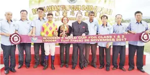  ??  ?? WINNER: Chin (fifth right) and his management team with the stable owner and jockey of the RSTC Gold Cup Race 2017 champion Zack.