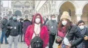  ?? AFP ?? Tourists wearing protective masks visit Venice even as the annual carnival was cancelled following the virus outbreak in Italy.
