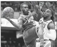  ?? AP/TONY DEJAK ?? New York Knicks’ Tim Hardaway Jr.
(left) passes around Cleveland Cavaliers’ Jae Crowder during their game Sunday in Cleveland. The Knicks won 114-95.