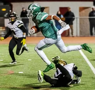  ?? Michael M. Santiago/Post-Gazette photos ?? South Fayette running back Andrew Franklin leaps over a Belle Vernon defender on his way to a touchdown.