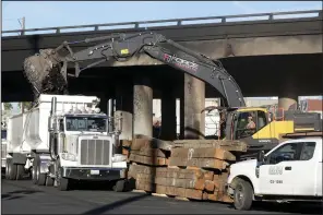  ?? (AP/The Orange County Register/Dean Musgrove) ?? Crews continue to clear debris and shore up a stretch of Interstate 10, Tuesday in Los Angeles.