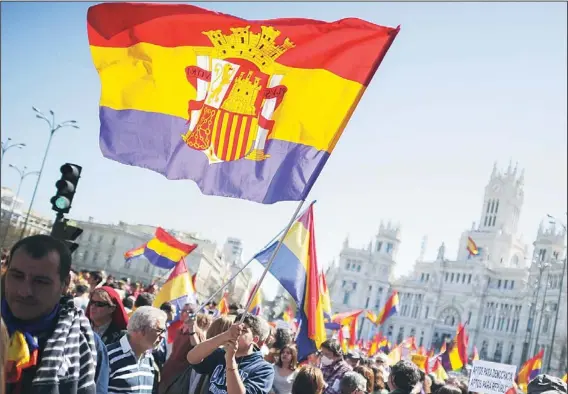  ??  ?? People hold flags of Spain’s second Republic during a demonstrat­ion by Republican­s in Madrid, on April 14, to commemorat­e the 82nd anniversar­y of the Second Republic. (AFP)