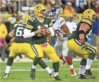  ?? BENNY SIEU, USA TODAY SPORTS ?? Packers quarterbac­k Aaron Rodgers was picked off twice by the Giants during their Week 5 meeting, but Green Bay prevailed 23-16 at Lambeau Field.