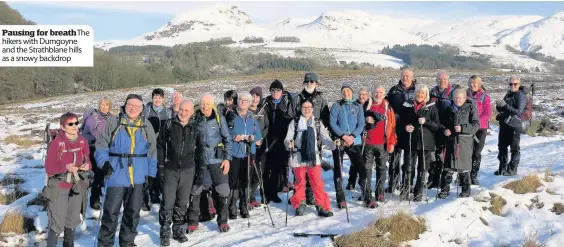  ??  ?? Pausing for breathThe hikers with Dumgoyne and the Strathblan­e hills as a snowy backdrop