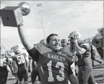  ?? ASHLEY LANDIS FOR AMERICAN-STATESMAN ?? Georgetown’s Chuy Perez holds up the 4A state semifinal championsh­ip trophy after a 42-14 win over Rouse on Saturday that sent Georgetown to the state final.