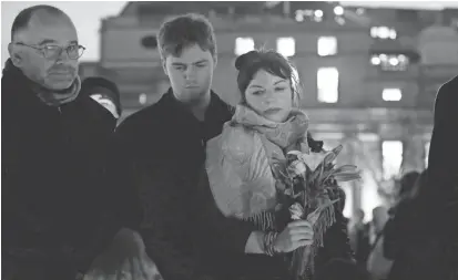  ?? MATT DUNHAM/AP ?? People attend a vigil Thursday at Trafalgar Square in London for the victims of Wednesday’s terrorist attack.