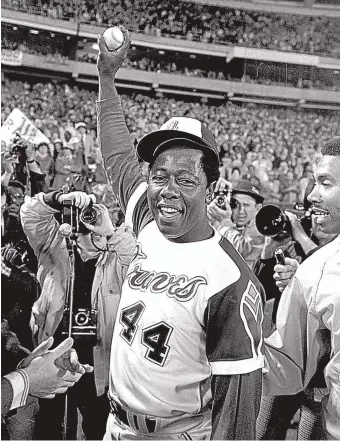  ?? BOB DAUGHERTY/ASSOCIATED PRESS FILE ?? In this 1974 photo, Hank Aaron holds the ball he hit for his 715th career home run in Atlanta Stadium against the Los Angeles Dodgers.